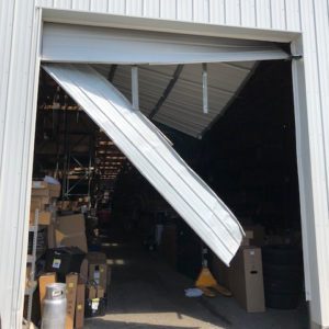 twisted commercial door off track